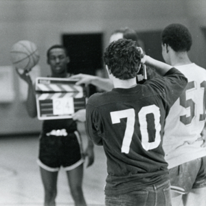 Steve Carver shooting footage of Billy Towns at Wohl Center during a basketball game during production of "More Than One Thing"